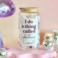 Decorative jar with a humorous quote on a pink stand with disco balls and a disco ball in the background.