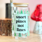Glass jar with a humorous label on a wooden surface with decorative items in the background