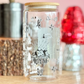 Glass jar with decorative elements on a wooden surface with a pink background
