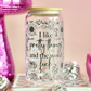 Glass jar with floral designs and text on a pink background